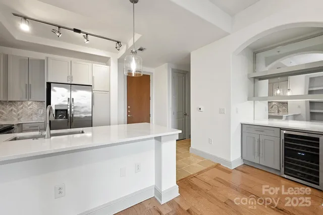 a large kitchen with kitchen island a sink stainless steel appliances and cabinets