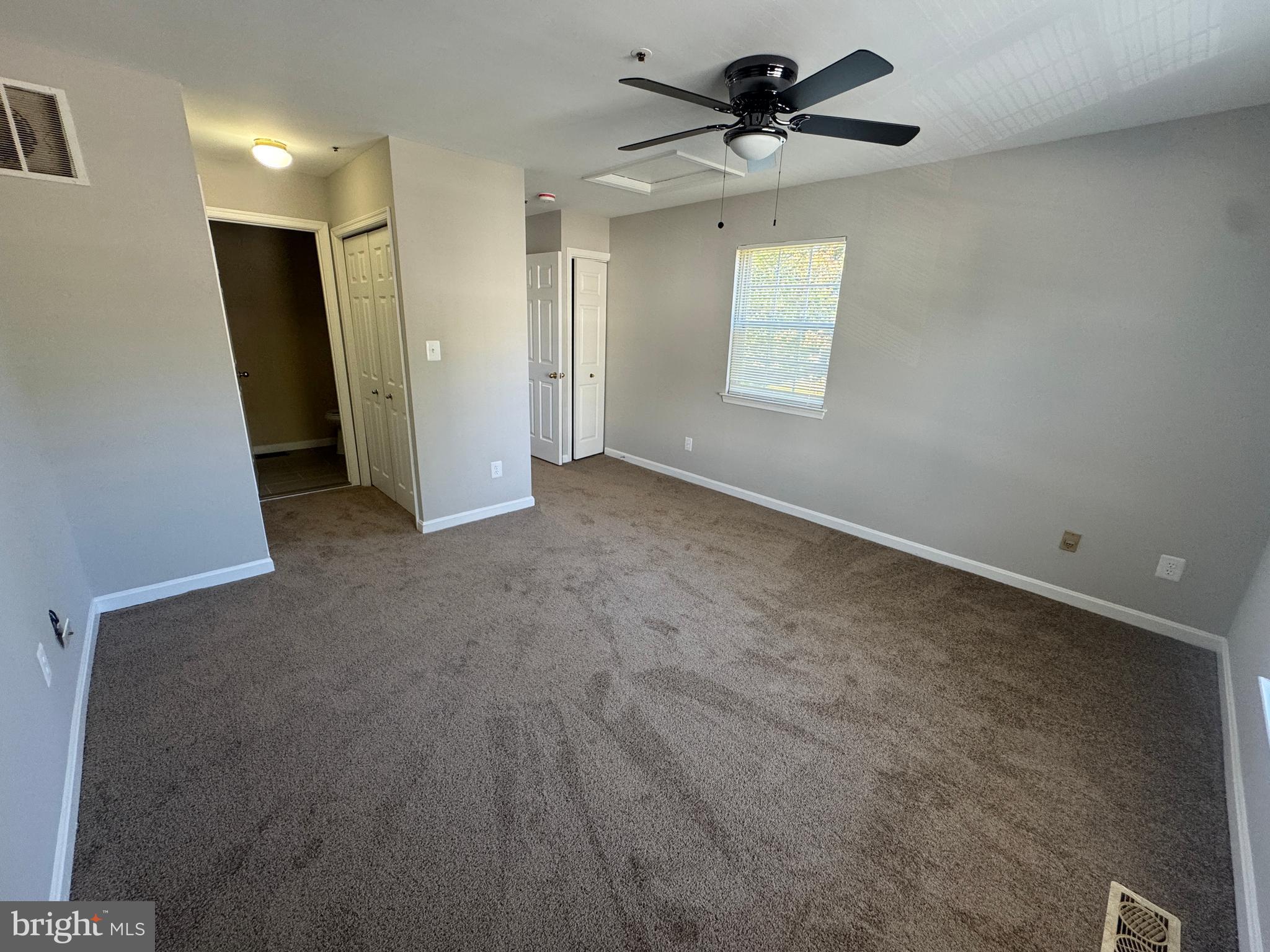 11263 Raging Brook Drive, Unit 253 Bowie, MD 20720 - Photo 17 of 22 a view of a livingroom with a ceiling fan and window