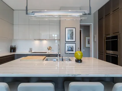 a kitchen with a table chairs and stainless steel appliances