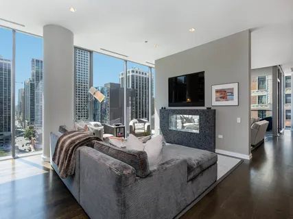 a living room with bed and a flat screen tv