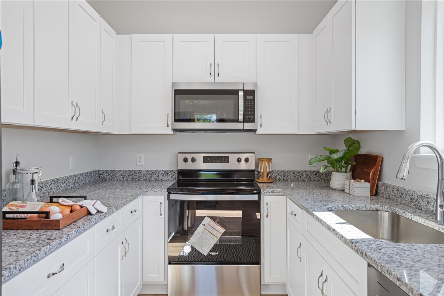 142 Eno Road Dickson, TN 37055 - Photo 7 of 17 a kitchen with granite countertop white cabinets and stainless steel appliances