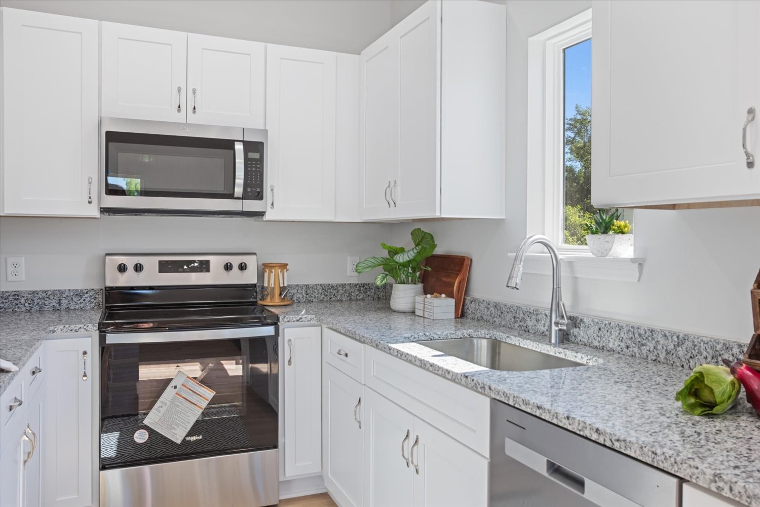 142 Eno Road Dickson, TN 37055 - Photo 8 of 17 a kitchen with stainless steel appliances granite countertop a sink a stove and a microwave
