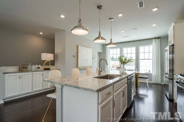 a kitchen with center island a sink stainless steel appliances and cabinets