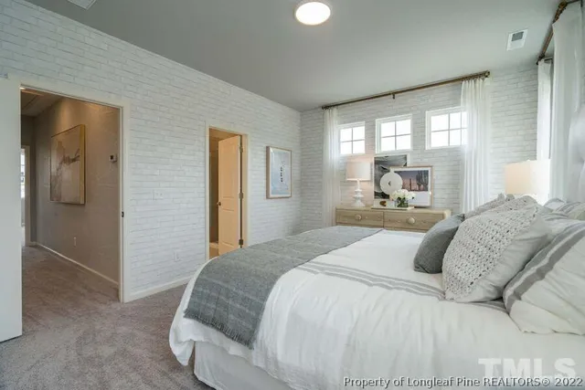 a bedroom with a large bed and a large window