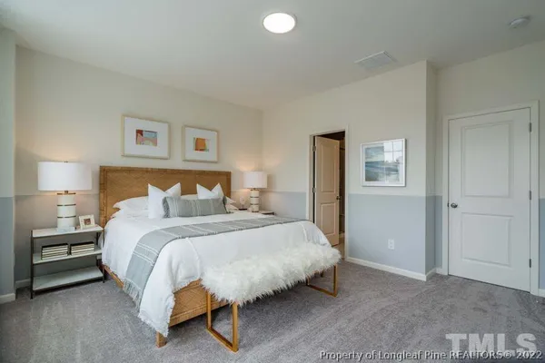 a bedroom with a bed and a lamp