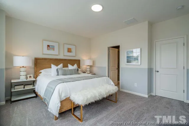 a bedroom with a bed and a lamp