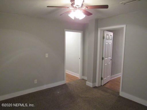 4909 Ave B Jacksonville, FL 32209 - Photo 12 of 17 an empty room with windows and fan