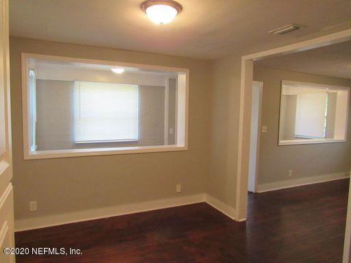 4909 Ave B Jacksonville, FL 32209 - Photo 17 of 17 an empty room with wooden floor and windows