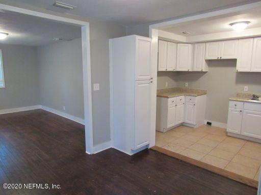 4909 Ave B Jacksonville, FL 32209 - Photo 6 of 17 a kitchen with stainless steel appliances a refrigerator and cabinets