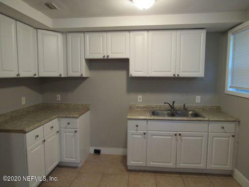 4909 Ave B Jacksonville, FL 32209 - Photo 7 of 17 a kitchen with white cabinets and sink