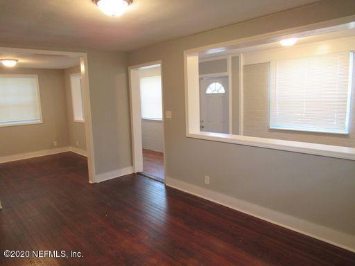 4909 Ave B Jacksonville, FL 32209 - Photo 8 of 17 a view of an empty room with wooden floor and a window