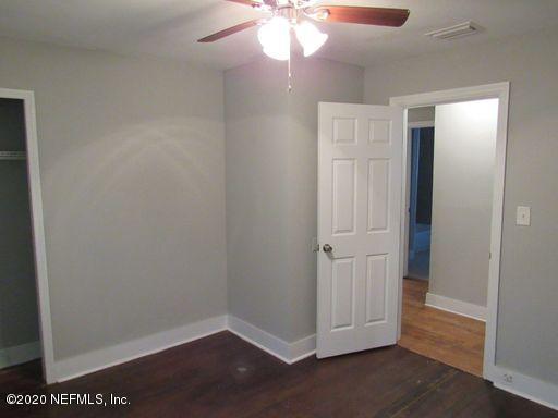 4909 Ave B Jacksonville, FL 32209 - Photo 9 of 17 an empty room with wooden floor and closet area