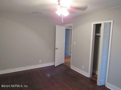 4909 Ave B Jacksonville, FL 32209 - Photo 10 of 17 an empty room with wooden floor and windows