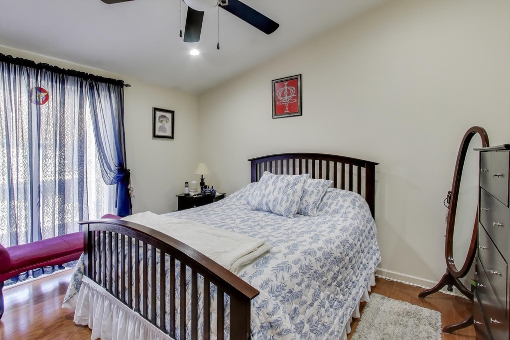 425 Main Street, Unit 11B Hudson, MA 01749 - Photo 12 of 26 a bedroom with a bed and a window