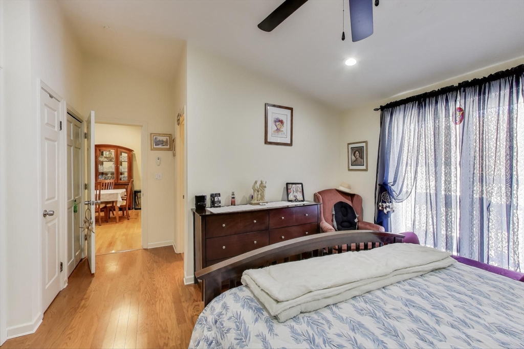 425 Main Street, Unit 11B Hudson, MA 01749 - Photo 13 of 26 a bedroom with a bed and a chandelier