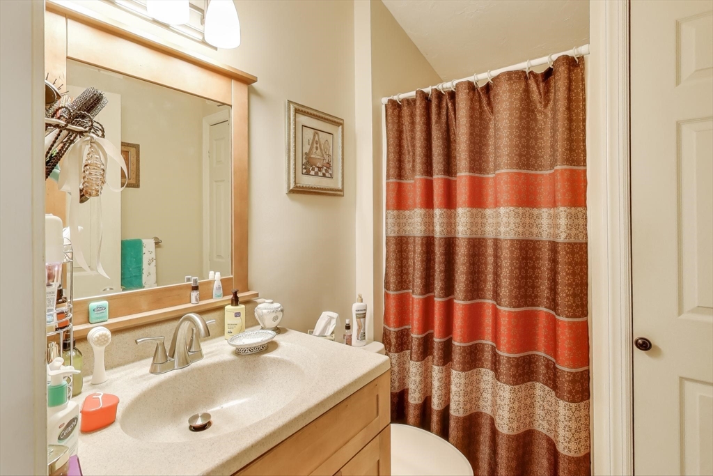 425 Main Street, Unit 11B Hudson, MA 01749 - Photo 15 of 26 a bathroom with a sink and a mirror