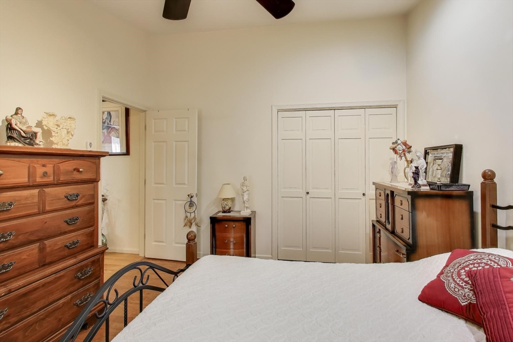 425 Main Street, Unit 11B Hudson, MA 01749 - Photo 17 of 26 a bedroom with a bed and a cabinets