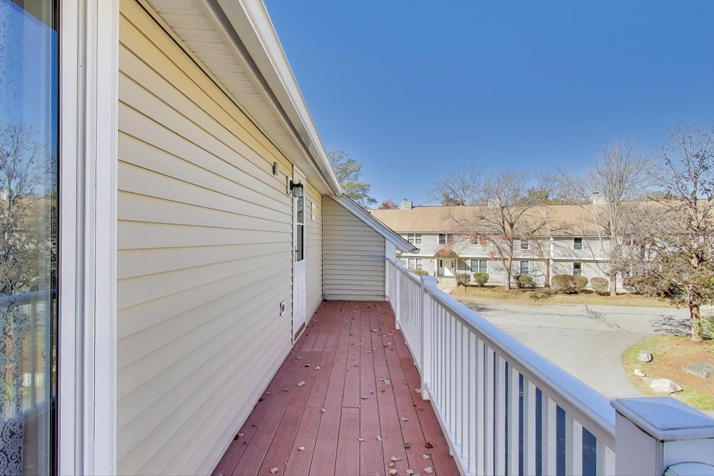 425 Main Street, Unit 11B Hudson, MA 01749 - Photo 20 of 26 a view of a balcony with wooden floor and fence