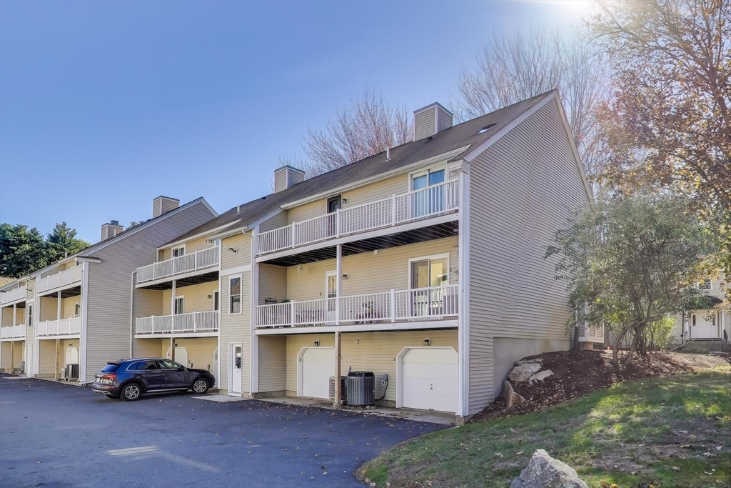 425 Main Street, Unit 11B Hudson, MA 01749 - Photo 22 of 26 a view of building with cars parked
