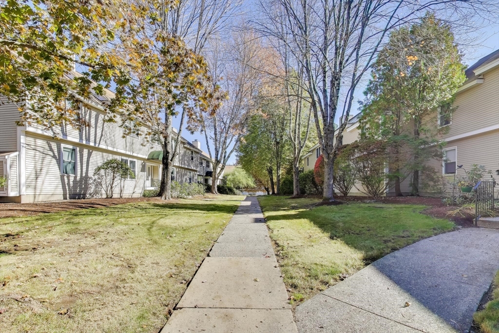 425 Main Street, Unit 11B Hudson, MA 01749 - Photo 3 of 26 a view of a yard with flower plants