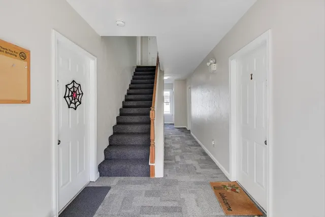 a view of entryway and hall with wooden floor