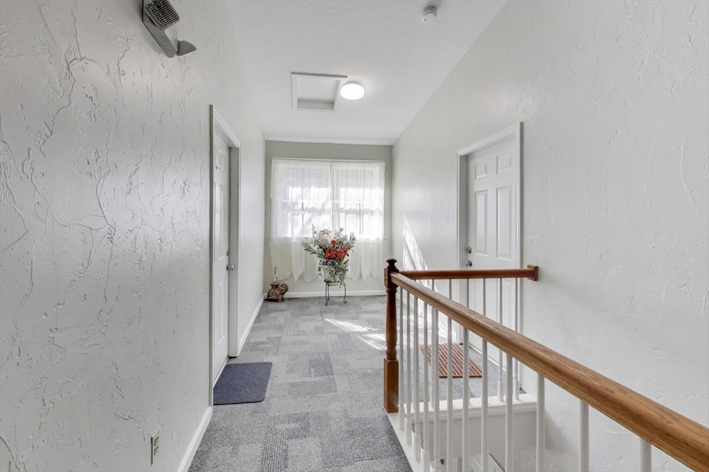 425 Main Street, Unit 11B Hudson, MA 01749 - Photo 5 of 26 a view of a hallway with a livingroom and stairs
