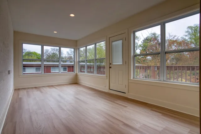 a balcony with wooden floor and fence