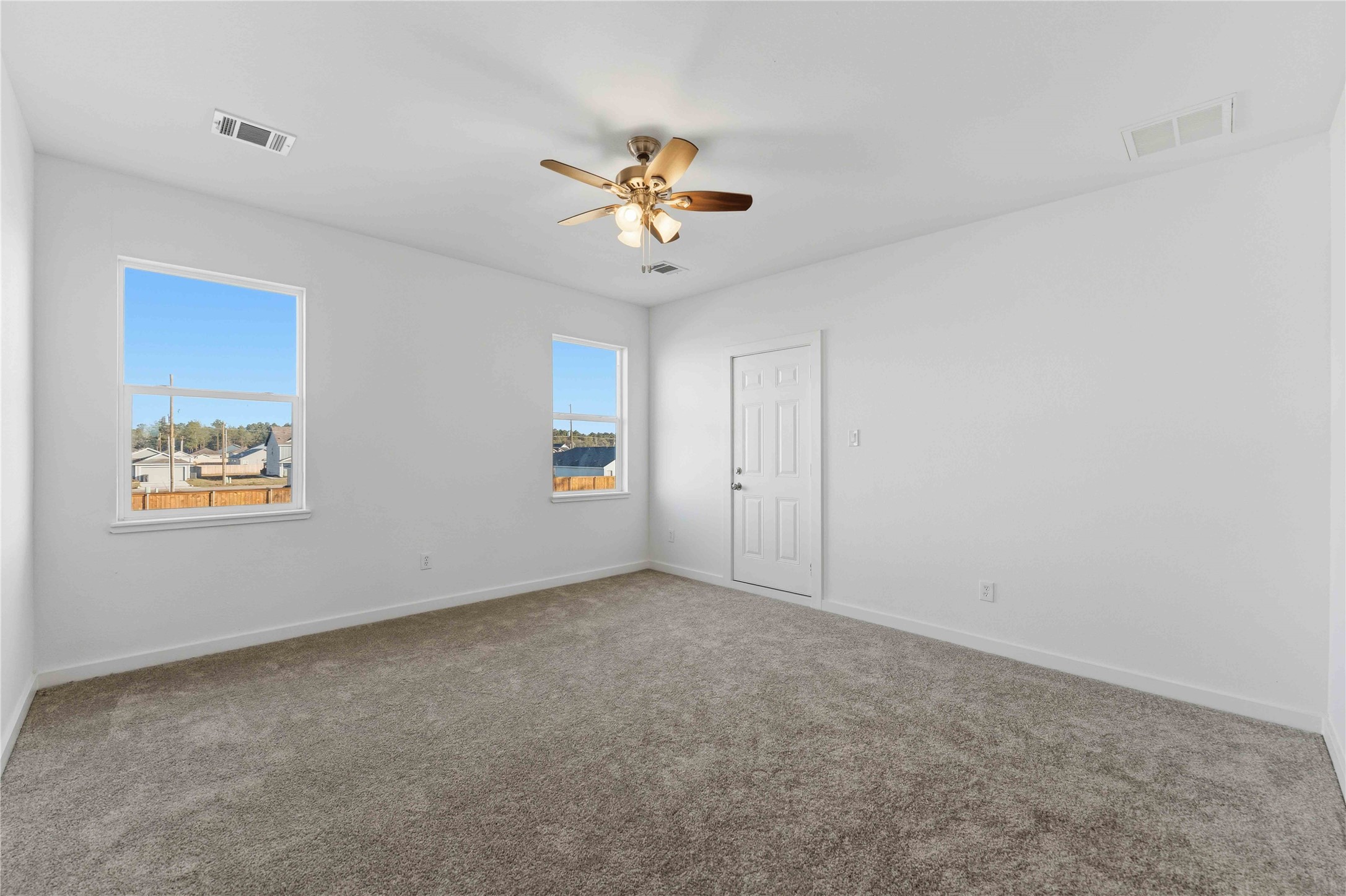 18611 Ratho Drive Conroe, TX 77306 - Photo 11 of 28 an empty room with windows and ceiling fan