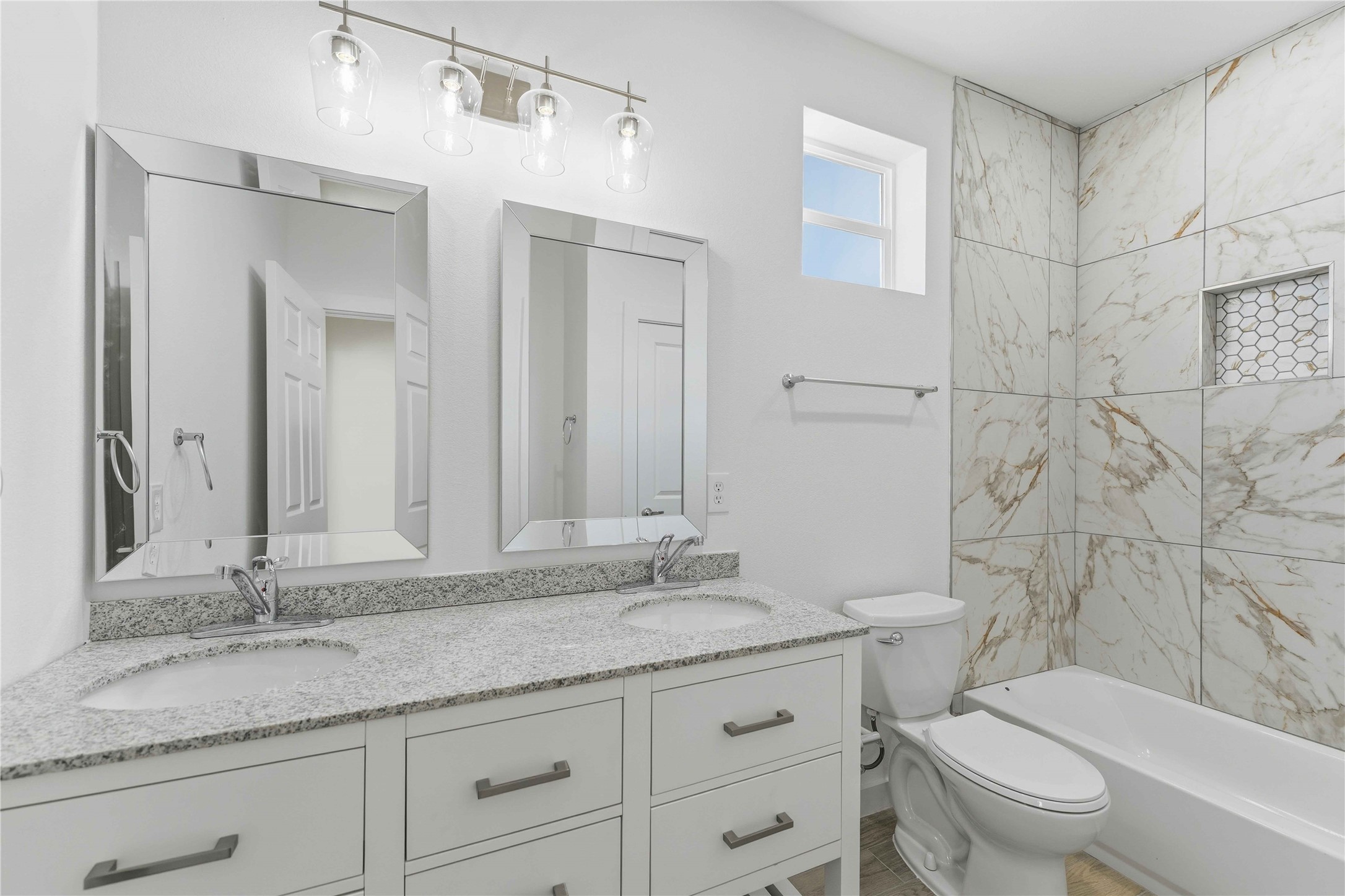 18611 Ratho Drive Conroe, TX 77306 - Photo 18 of 28 a bathroom with a granite countertop sink a toilet and a mirror