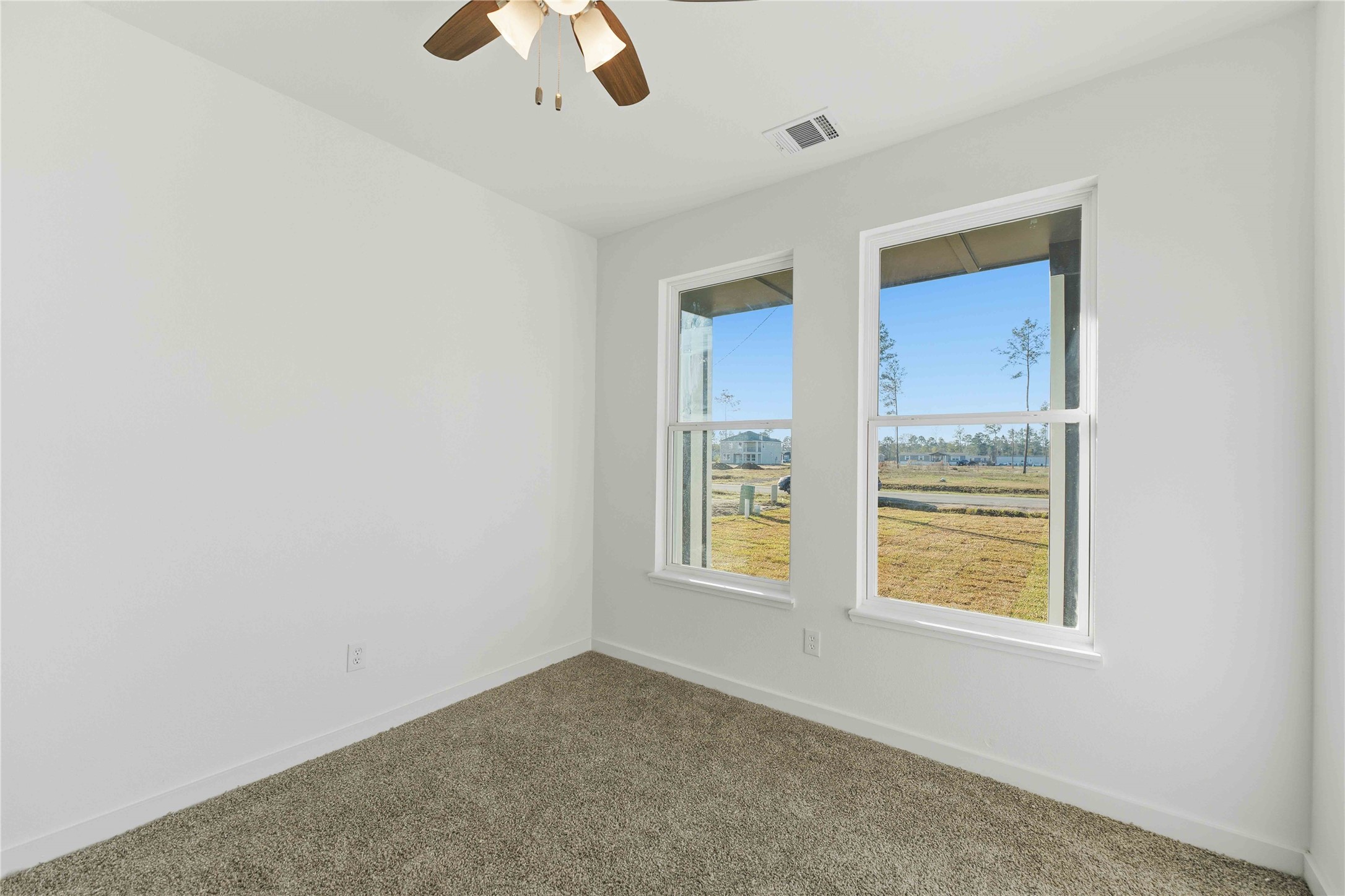 18611 Ratho Drive Conroe, TX 77306 - Photo 22 of 28 an empty room with window and ceiling fan