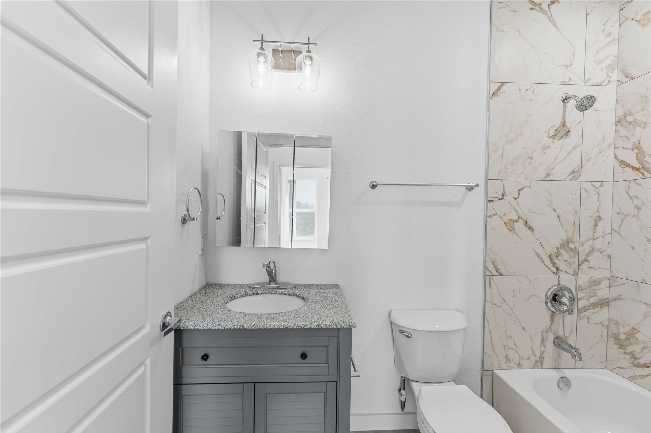 18611 Ratho Drive Conroe, TX 77306 - Photo 24 of 28 a bathroom with a granite countertop sink toilet and shower