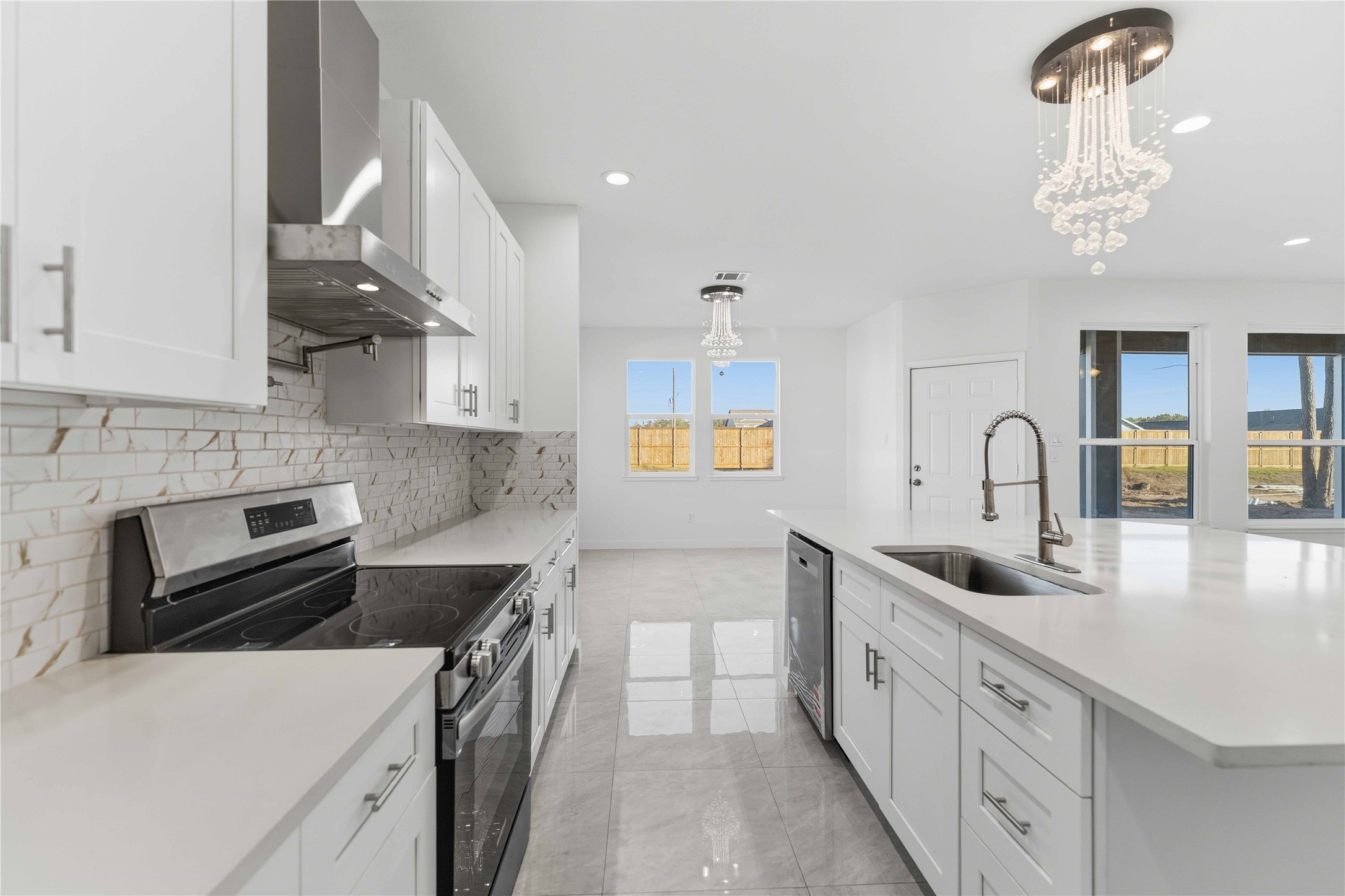 18611 Ratho Drive Conroe, TX 77306 - Photo 5 of 28 a kitchen with stainless steel appliances granite countertop a sink stove and cabinets