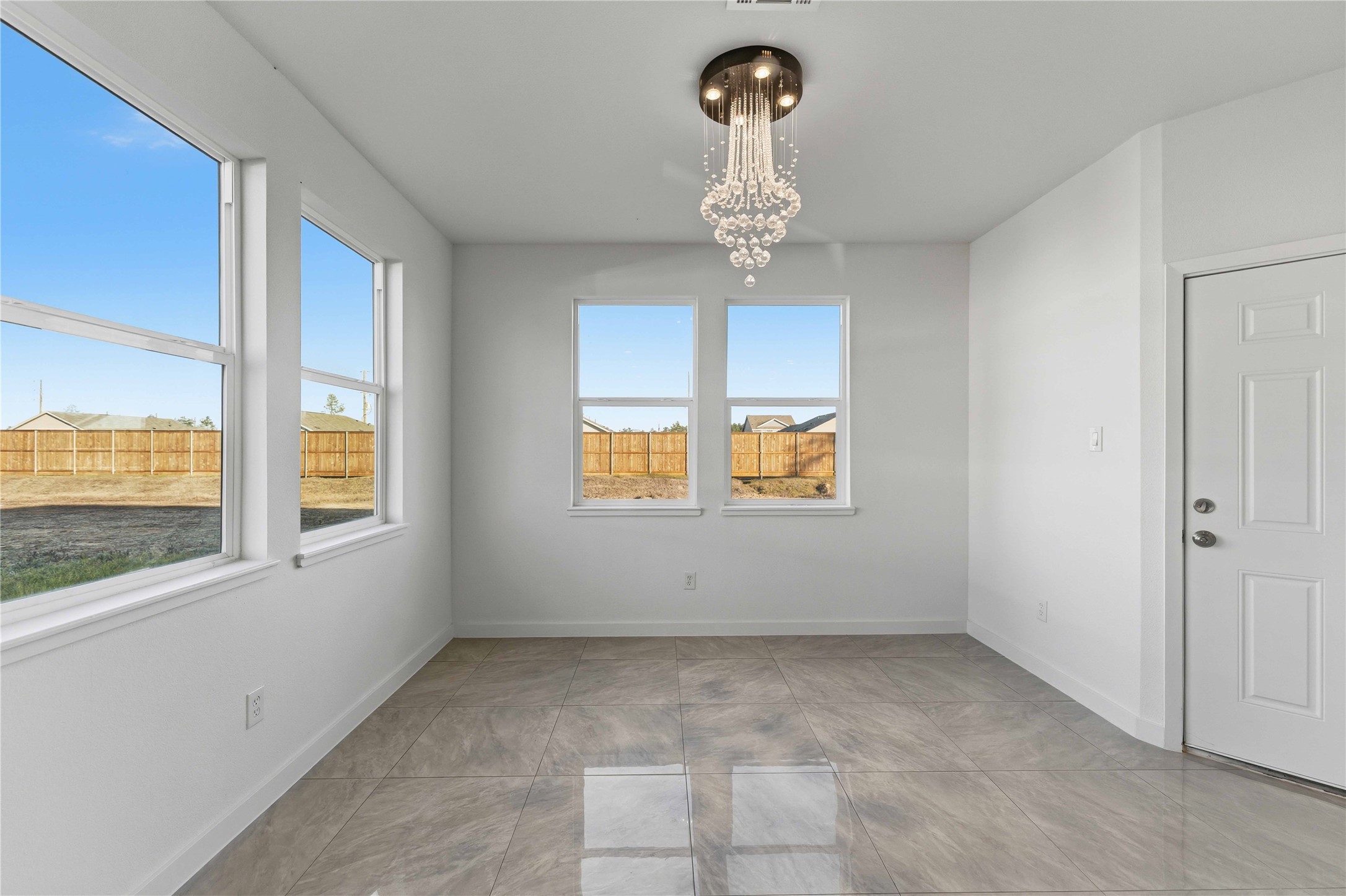 18611 Ratho Drive Conroe, TX 77306 - Photo 6 of 28 a view of a room that has a window and a chandelier