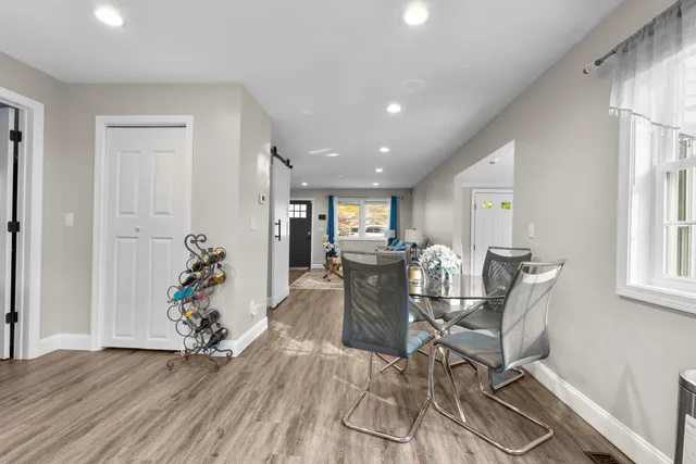 a view of a dining room with furniture window and wooden floor