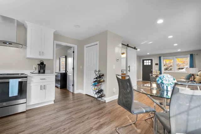 a living room with furniture or wooden floor and a kitchen