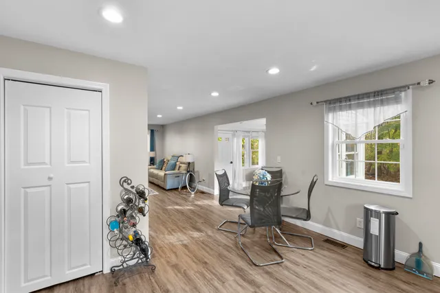 a view of a livingroom with furniture a table and wooden floor
