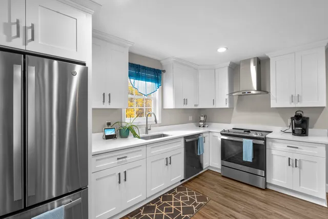 a kitchen with a sink stove and refrigerator