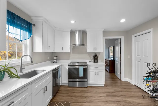 a kitchen with a stove a sink and a refrigerator