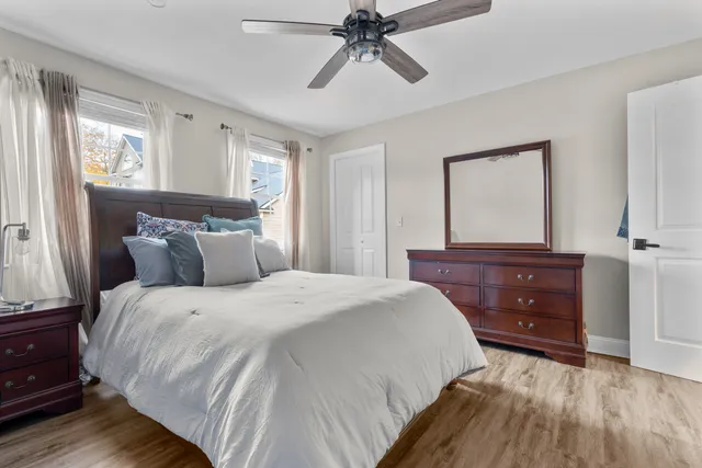 a bedroom with a bed and a mirror on the dresser