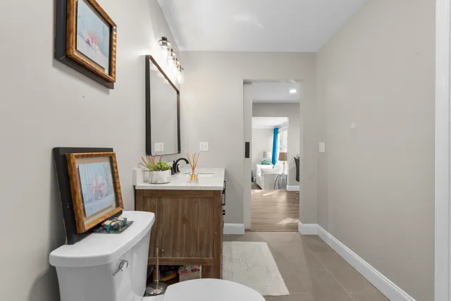a bathroom with a toilet a sink and mirror