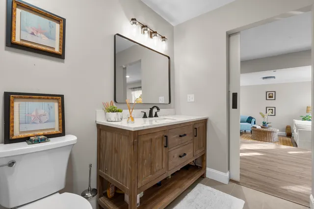 a bathroom with a double vanity sink mirror and toilet