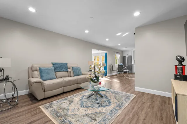 a living room with furniture and wooden floor