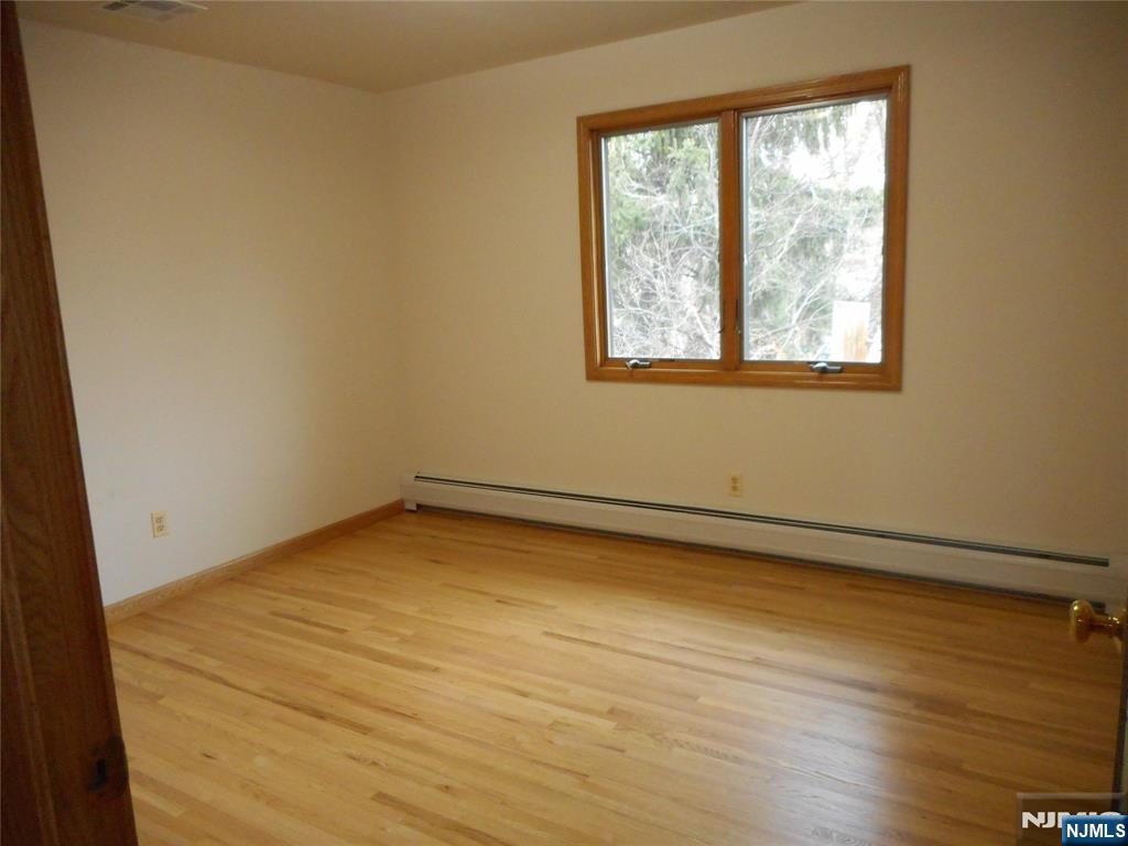 137 River Road, Unit 137 Clifton, NJ 07014 - Photo 11 of 21 an empty room with a window