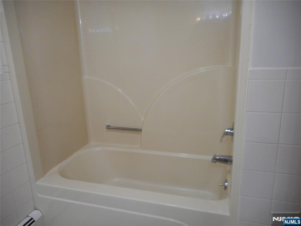 137 River Road, Unit 137 Clifton, NJ 07014 - Photo 14 of 21 a close up of a bathtub in a bathroom