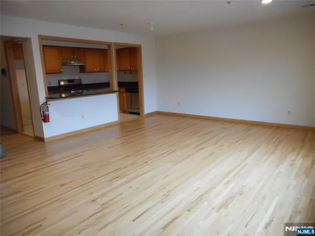 a view of a kitchen with wooden floor and a sink