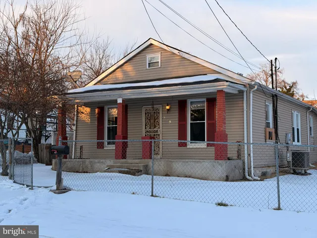 a front view of a house with basket ball court and outdoor seating
