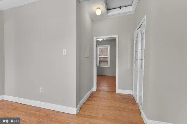 a view of a hallway with wooden floor