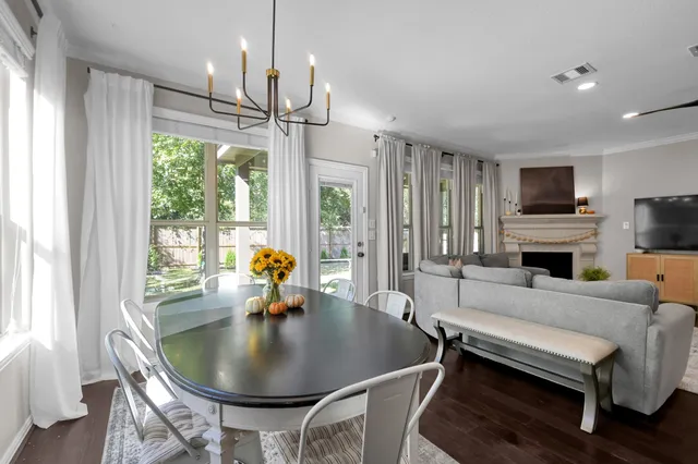 a kitchen with stainless steel appliances granite countertop a stove a sink dishwasher and a refrigerator with wooden floor