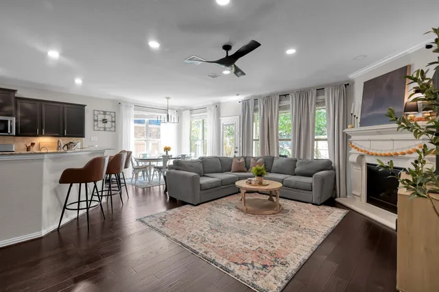 a dining room with furniture a chandelier and wooden floor
