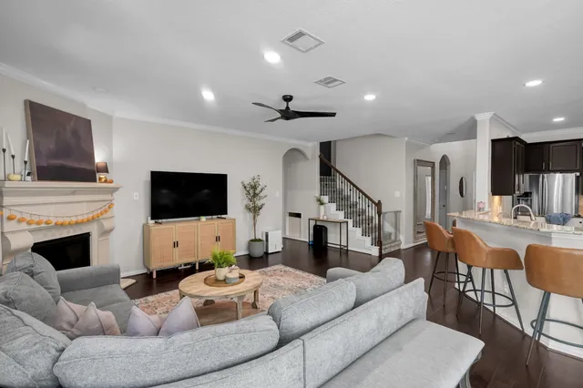 a kitchen with stainless steel appliances granite countertop a stove top oven a dining table and chairs with wooden floor